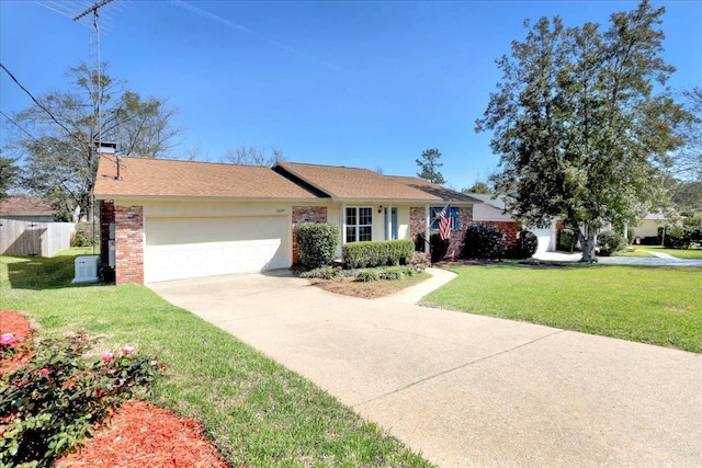 single story home with brick siding, concrete driveway, an attached garage, a front yard, and fence