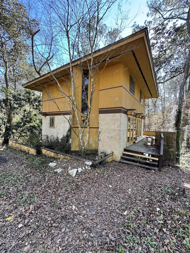 view of side of home with a deck