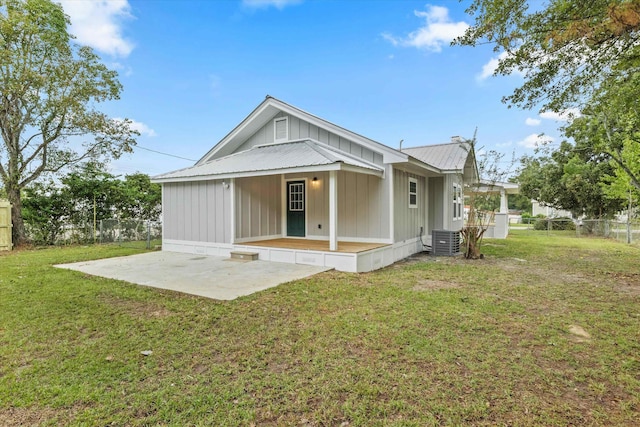 back of property featuring a lawn, fence, central AC unit, and a patio area