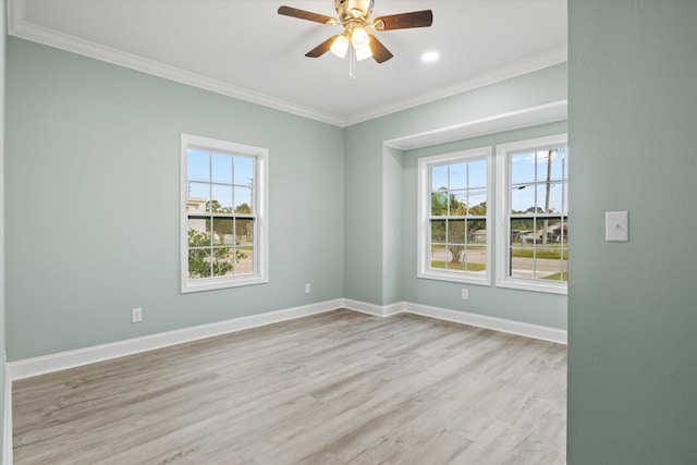 empty room featuring light wood-type flooring, crown molding, a healthy amount of sunlight, and ceiling fan