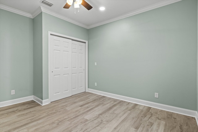 unfurnished bedroom with crown molding, baseboards, light wood-style flooring, and visible vents