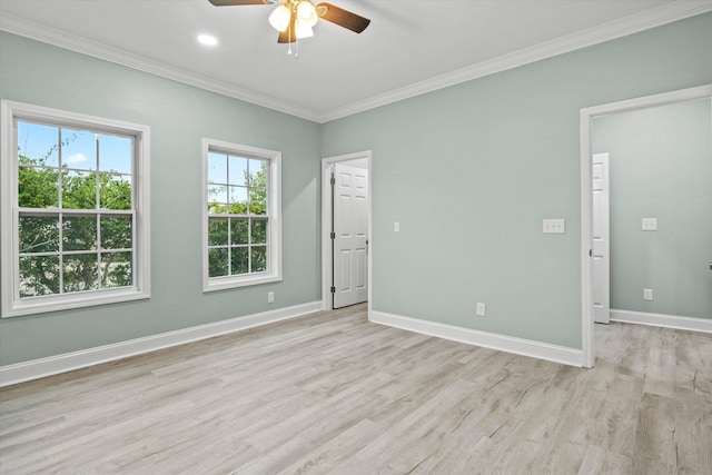 empty room with crown molding, ceiling fan, baseboards, and light wood-style floors