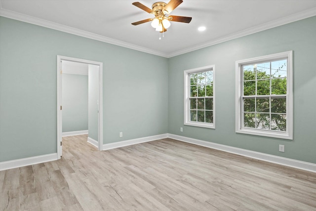 empty room featuring baseboards, ornamental molding, light wood-type flooring, and ceiling fan