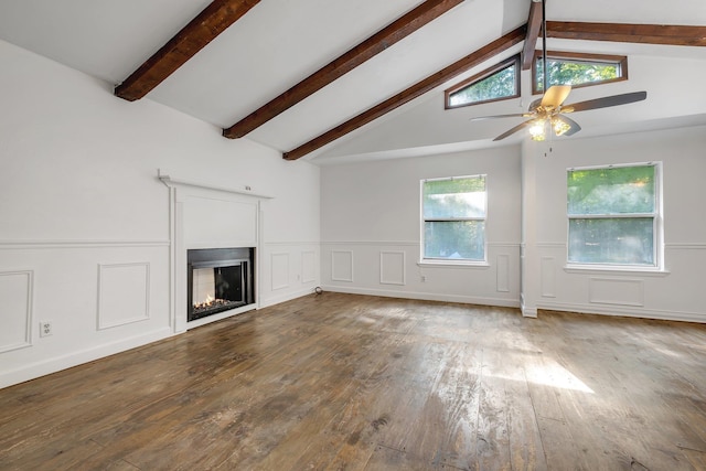 3200 Tallavana Trl, Havana, FL 32333 - unfurnished living room with hardwood / wood-style flooring, beamed ceiling, a lit fireplace, a decorative wall, and wainscoting