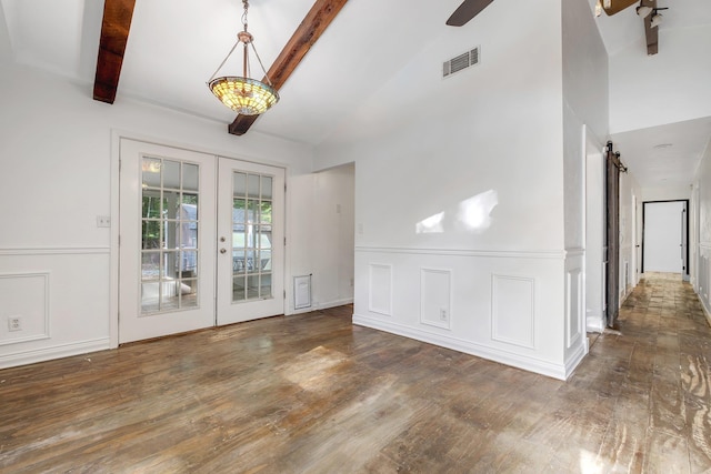 3200 Tallavana Trl, Havana, FL 32333 - unfurnished dining area with french doors, a barn door, wood finished floors, beamed ceiling, and ceiling fan