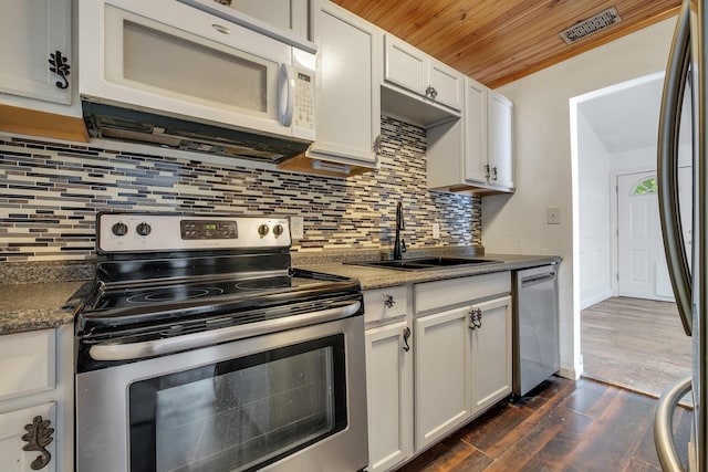 3200 Tallavana Trl, Havana, FL 32333 - kitchen featuring appliances with stainless steel finishes, wooden ceiling, dark wood finished floors, white cabinets, and tasteful backsplash