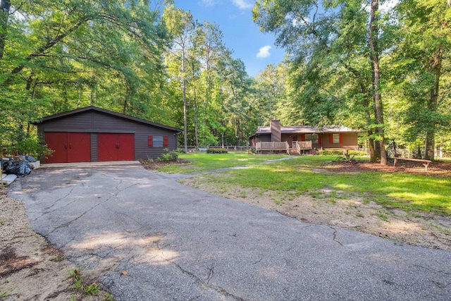 3200 Tallavana Trl, Havana, FL 32333 - view of green lawn with a detached garage, an outdoor structure, and a forest view