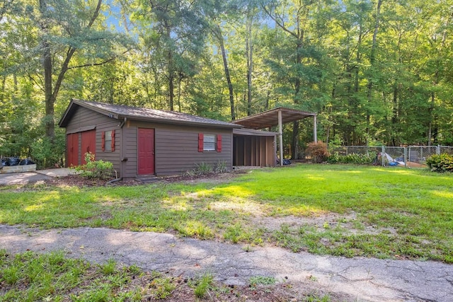 3200 Tallavana Trl, Havana, FL 32333 - view of side of property with an outbuilding, a detached carport, and a forest view