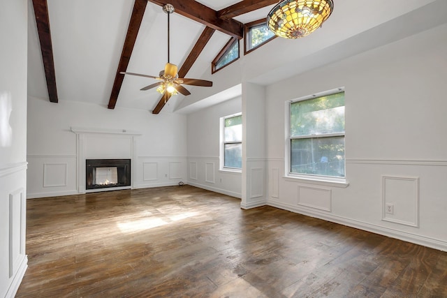 3200 Tallavana Trl, Havana, FL 32333 - unfurnished living room with wood finished floors, a wainscoted wall, a glass covered fireplace, a decorative wall, and ceiling fan