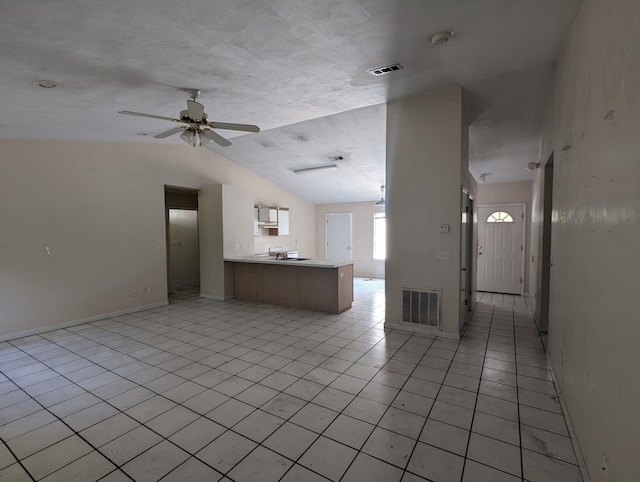 2218 Amelia Cir, Tallahassee, FL 32304 - unfurnished living room with light tile patterned floors, lofted ceiling, visible vents, and a ceiling fan