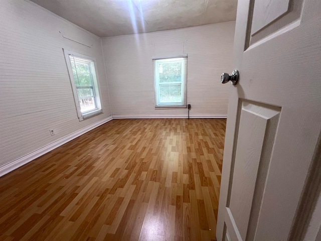 unfurnished room with light hardwood / wood-style floors