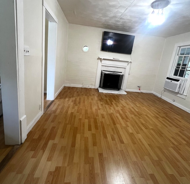 unfurnished living room with wood-type flooring and cooling unit