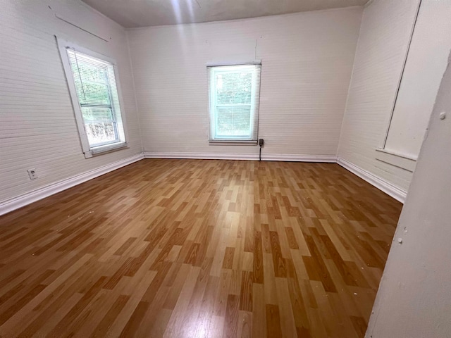 empty room with hardwood / wood-style flooring