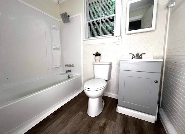 full bathroom with toilet, washtub / shower combination, vanity, and hardwood / wood-style floors