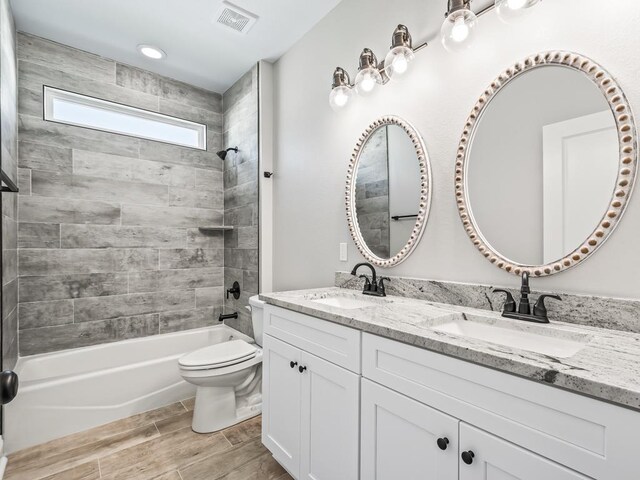 240 Ante Beppum Loop, Carrabelle, FL 32322 - bathroom featuring double vanity, shower / tub combination, toilet, and wood finished floors