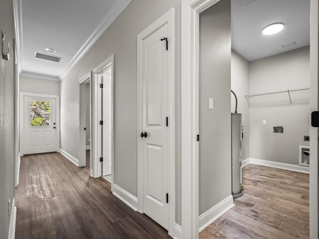 hallway featuring ornamental molding, water heater, and dark hardwood / wood-style floors