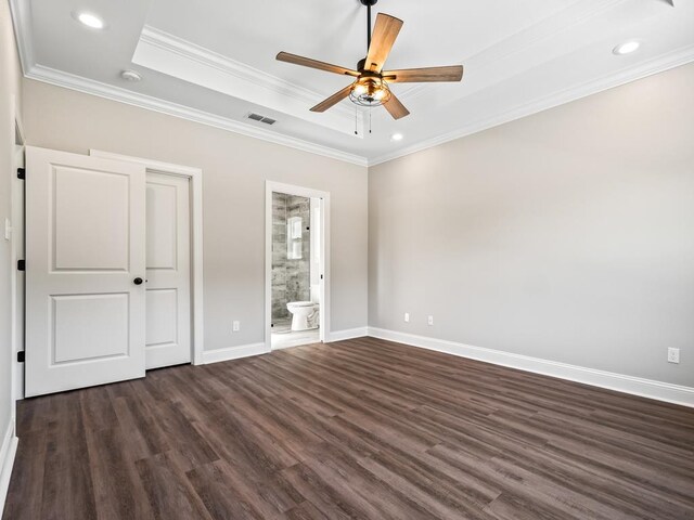 unfurnished bedroom with ornamental molding, ceiling fan, dark hardwood / wood-style floors, and connected bathroom