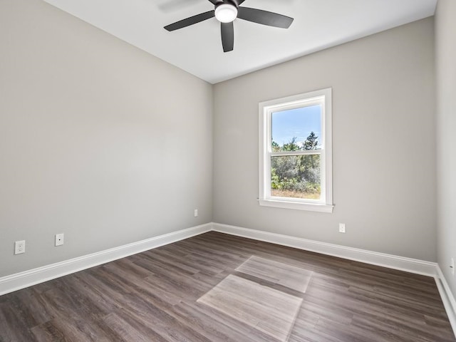 empty room with ceiling fan and dark hardwood / wood-style floors