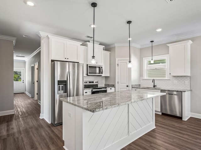 kitchen featuring white cabinetry, appliances with stainless steel finishes, a healthy amount of sunlight, and a center island