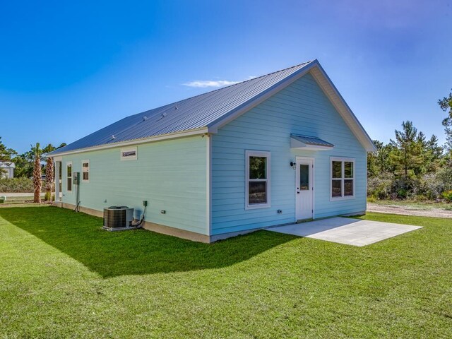 240 Ante Beppum Loop, Carrabelle, FL 32322 - back of house featuring a patio area, a yard, metal roof, and central AC