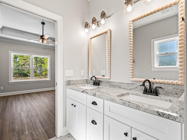 bathroom with a wealth of natural light, ceiling fan, vanity, and hardwood / wood-style flooring