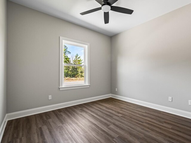 unfurnished room with dark hardwood / wood-style flooring and ceiling fan