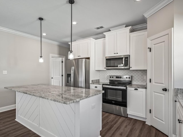 kitchen featuring white cabinetry, appliances with stainless steel finishes, light stone countertops, hanging light fixtures, and dark wood-type flooring