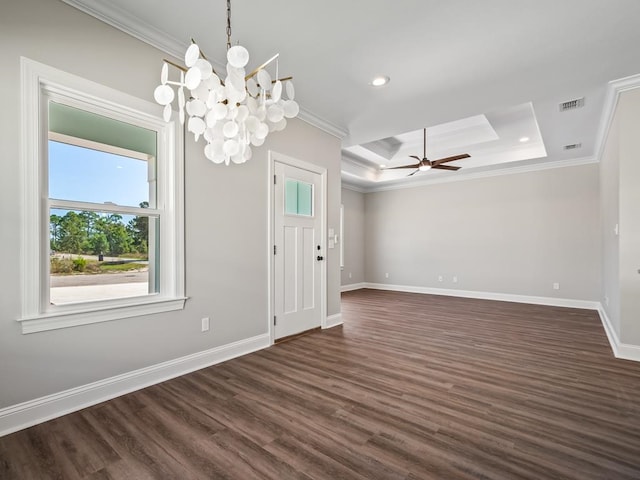 interior space featuring ornamental molding, ceiling fan with notable chandelier, dark hardwood / wood-style flooring, and a raised ceiling