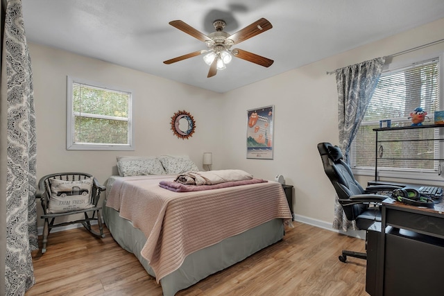 bedroom with ceiling fan and light wood-type flooring