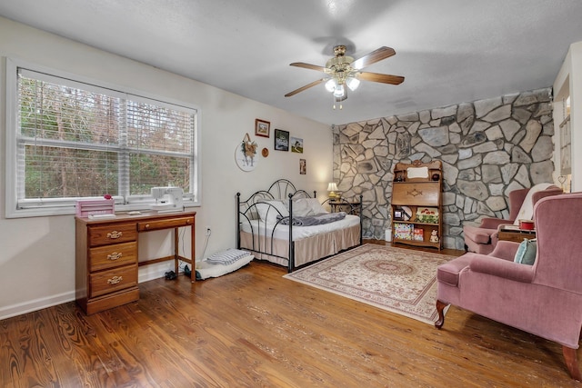 bedroom featuring hardwood / wood-style floors and ceiling fan