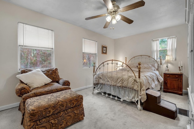 bedroom featuring light colored carpet and ceiling fan