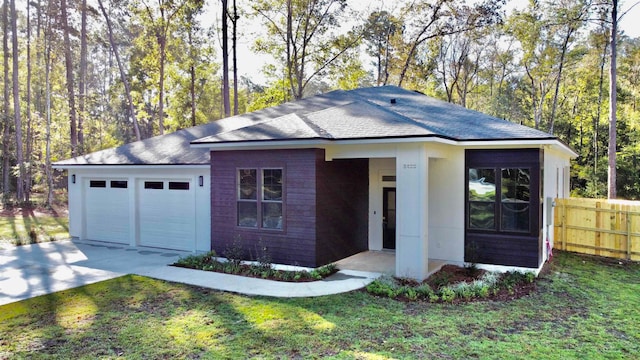 view of front of house featuring a front yard and a garage