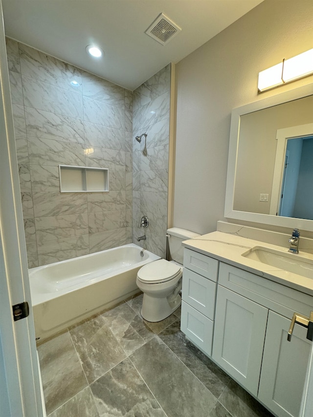 full bathroom with vanity, toilet, and tiled shower / bath