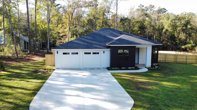 view of front of house featuring a front lawn and a garage