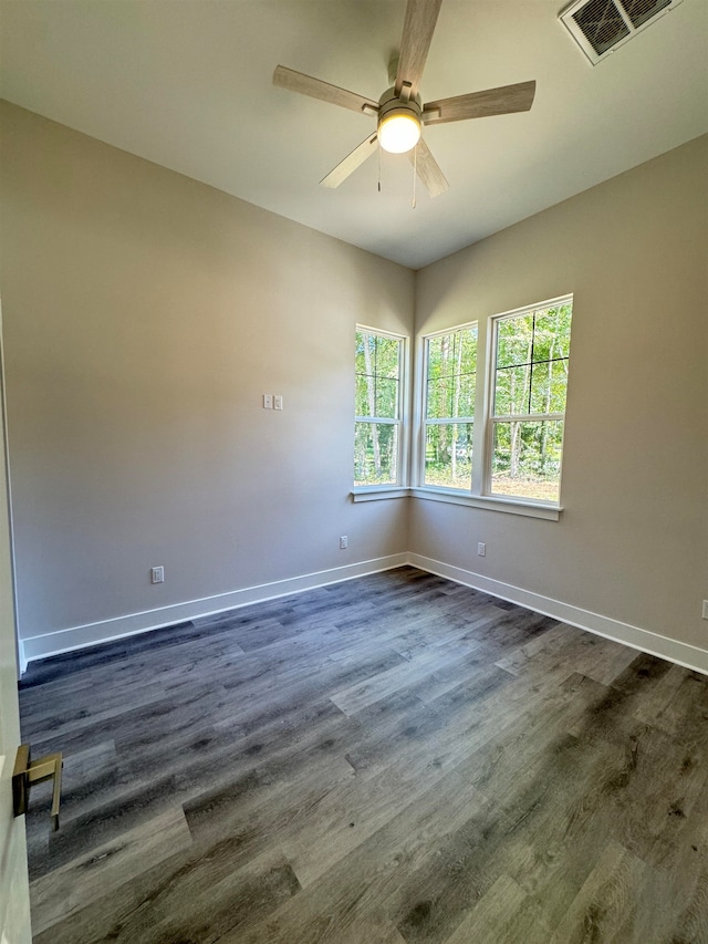 unfurnished room featuring ceiling fan and dark wood-type flooring