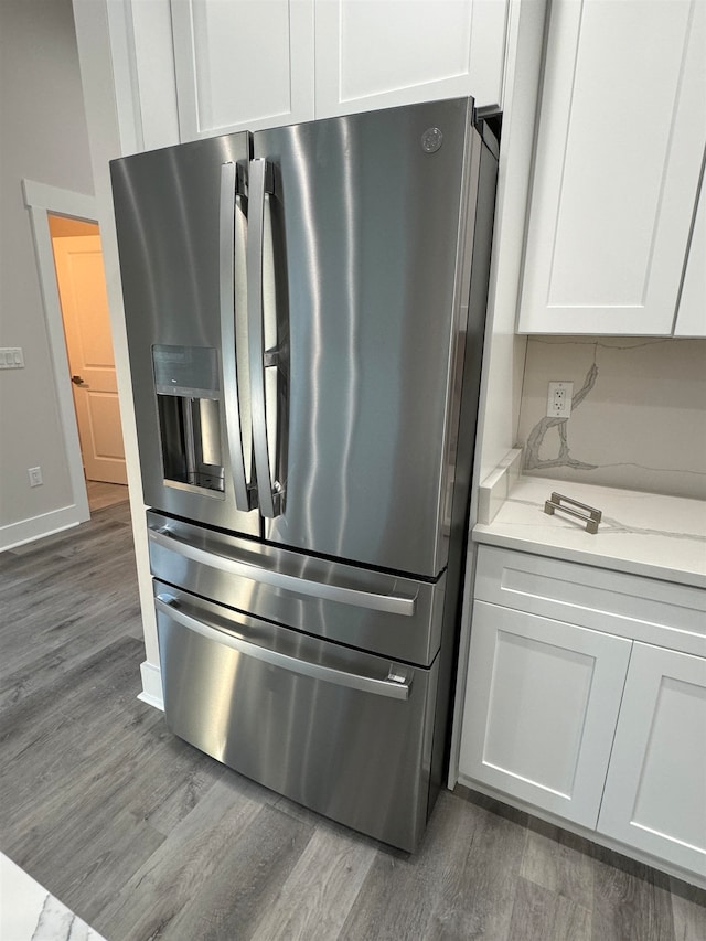 kitchen featuring stainless steel fridge with ice dispenser, white cabinetry, and dark wood-type flooring