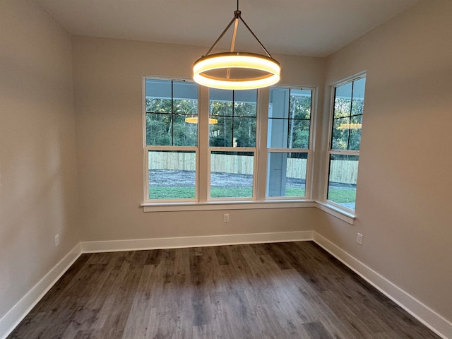 unfurnished dining area with dark hardwood / wood-style floors