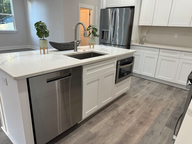 kitchen with sink, white cabinets, and appliances with stainless steel finishes