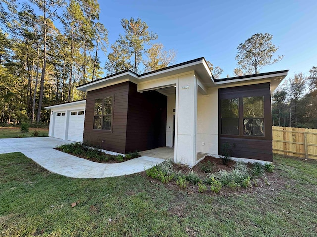 view of home's exterior with a lawn and a garage