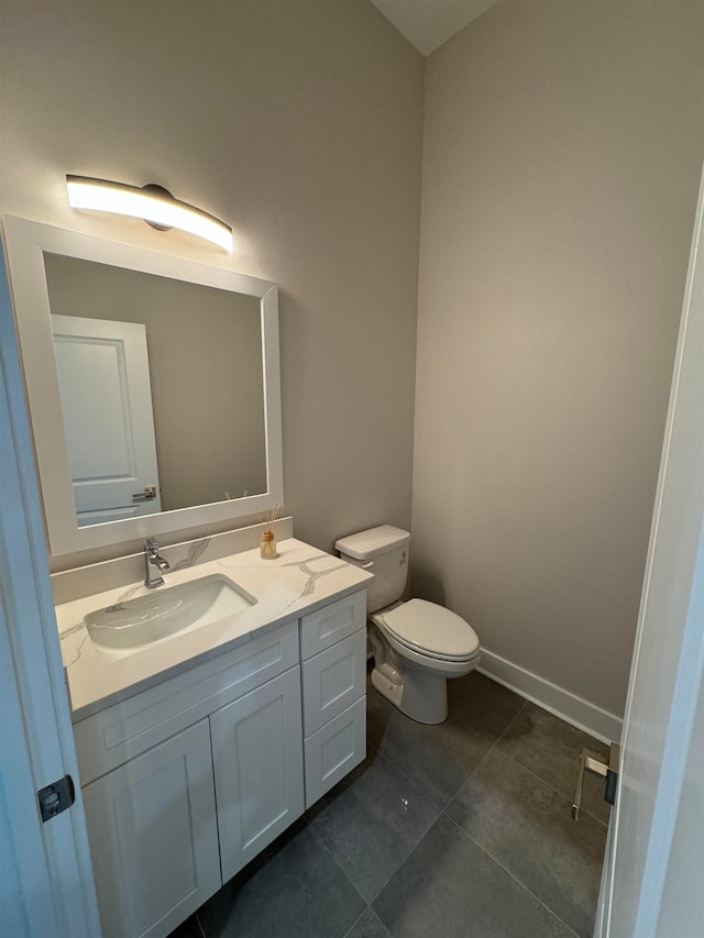 bathroom featuring tile patterned floors, vanity, and toilet