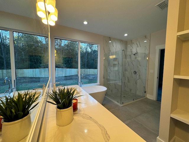 bathroom featuring tile patterned flooring and shower with separate bathtub