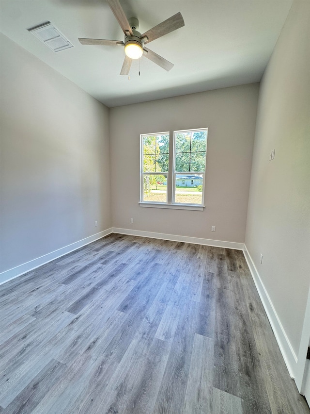 unfurnished room with hardwood / wood-style flooring and ceiling fan