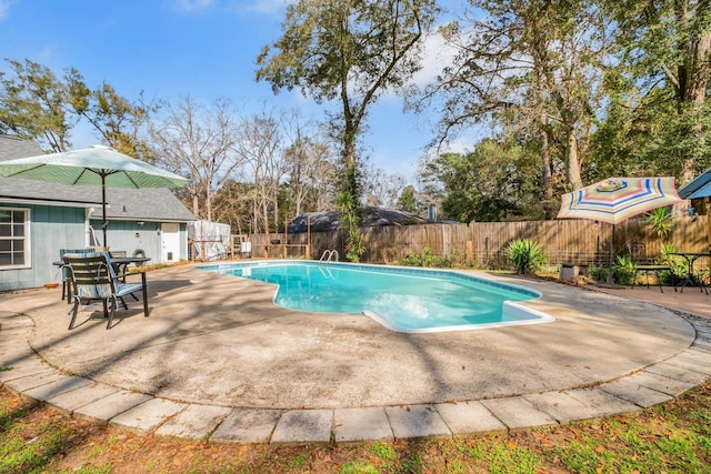 view of swimming pool featuring a patio area