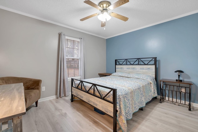 bedroom with crown molding, ceiling fan, a textured ceiling, and light wood-type flooring