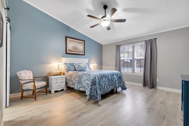 bedroom featuring vaulted ceiling, a textured ceiling, crown molding, and light hardwood / wood-style flooring