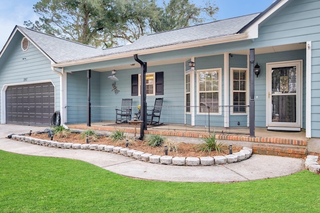 ranch-style home with a porch, a garage, and a front lawn