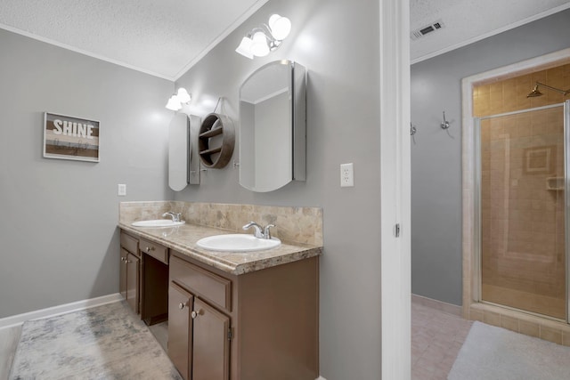 bathroom with crown molding, vanity, a textured ceiling, and walk in shower