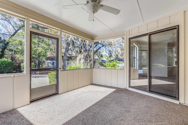 unfurnished sunroom with ceiling fan