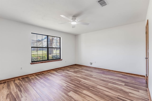 unfurnished room with ceiling fan and light wood-type flooring