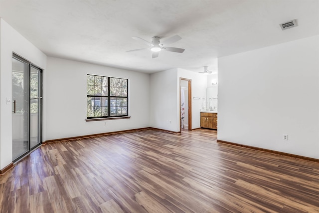 empty room with hardwood / wood-style flooring and ceiling fan